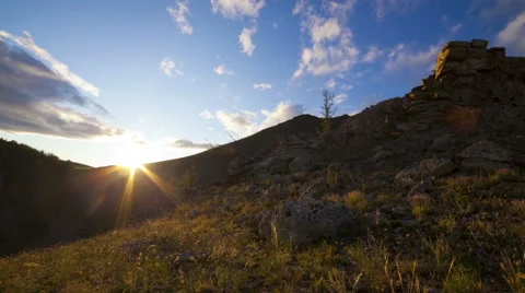 Sunset clouds over rocks timelapse Stock Footage 47084596