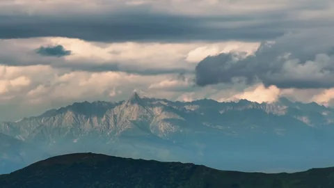 Sunset clouds over rocky alpine mountains in summer evening nature Time lapse Video stock 108742053