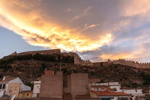Sunset clouds over the walls of an ancient castle Stock Photos