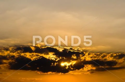 Sunset in clouds Stock Photos