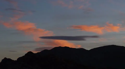 Sunset Clouds of Saturated Colors Over a Desert Landscape Stock Footage 35272537