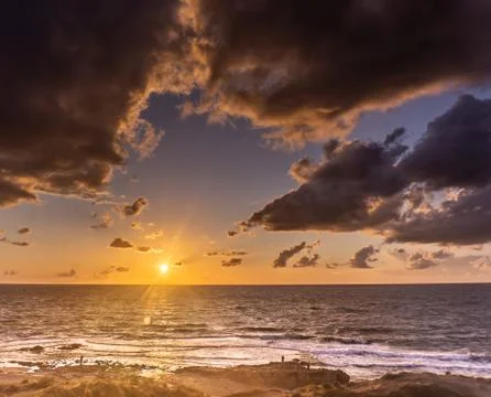 Sunset clouds on sea beach of romantic vacation Stock Photos
