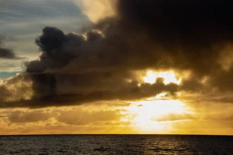 Sunset clouds in the sea Stock Photos