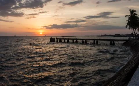 Sunset with clouds on the seashore Stock Photos