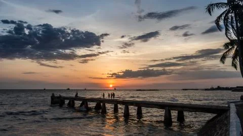 Sunset with clouds on the seashore Stock Photos
