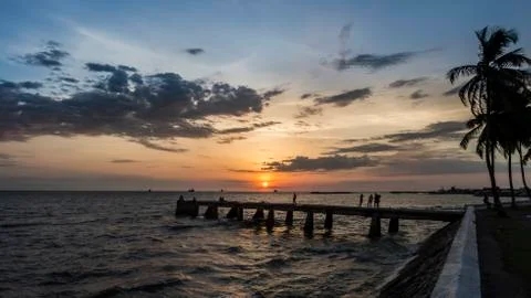 Sunset with clouds on the seashore Stock Photos