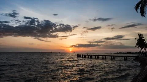 Sunset with clouds on the seashore Stock Photos
