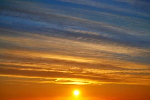 Sunset clouds sky in orange and blue Stock Photos