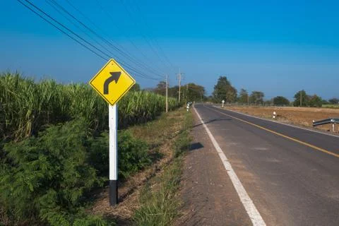 Sunset in clouds with sunrays over road to horizon Stock Photos