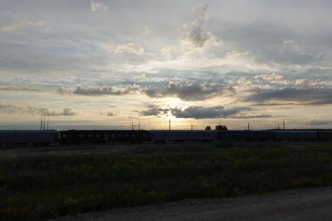 Sunset with clouds with a train in the background Stock Photos