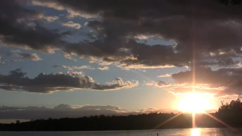 Sunset clouds w amber rain shower timelapse Stock Footage 187801636