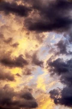 Sunset cloudscape atmospheric layers with radiant orange yellow illumination Stock-Fotos
