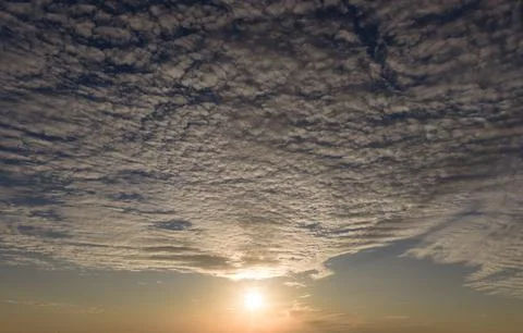 Sunset in cloudscape background. Sunset rays on sky. Sunset glowing twilight. Stock Photos