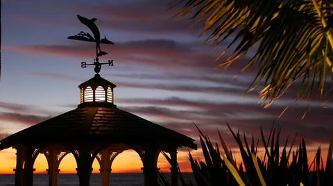 Sunset cloudscape, gazebo on beach, twilight dusk, dramatic sky. Alcove and vane Stock Photos