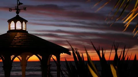 Sunset cloudscape, gazebo on beach, twilight dusk, dramatic sky. Alcove and vane Stock Photos