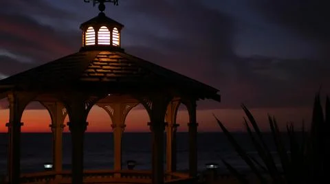 Sunset cloudscape, gazebo on beach, twilight dusk, dramatic sky. Alcove and vane Stock Photos