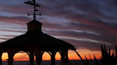 Sunset cloudscape, gazebo on beach, twilight dusk, dramatic sky. Alcove and vane Stock Photos