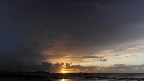 Sunset in a cloudy and rainy sky over the sea in time-lapse. View of a seahore. Stock Footage 88167960