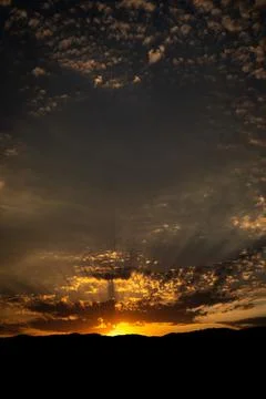 Sunset on a cloudy day with sun rays Foto stock