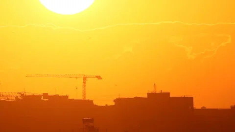 Sunset in cloudy sky above town Stock Footage 123698638