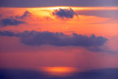 Sunset cloudy sky over ocean water. Landscape. Stock Photos