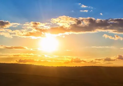 Sunset in cloudy sky Stock Photos