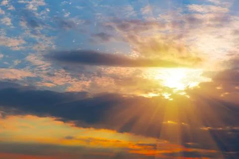 Sunset in the cloudy sky Stock Photos