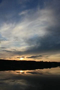 Sunset cloudy sky reflected in forest lake landscape photo Stock Photos