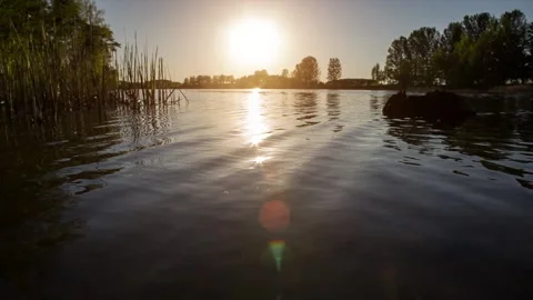 Sunset at coast of the lake.	 Stock Footage 90360944