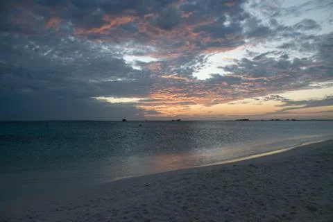 Sunset on the coast lighting the clouds Stock Photos