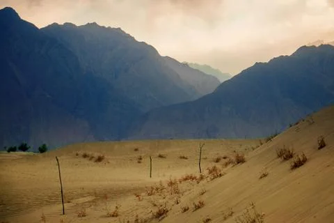 Sunset at cold desert with beutiful layer of mountains Stock Photos
