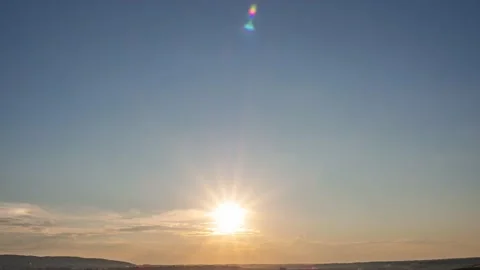 Sunset color clouds fly across a bright blue sky Stock Footage 210074500