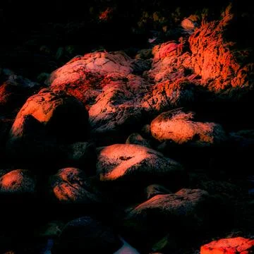 Sunset-colored rock texture with digital enhancement Stock Photos