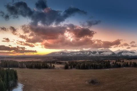 Sunset with colorful clouds on the meadows below the Western Tatras Stock Photos