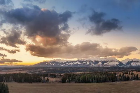 Sunset with colorful clouds on the meadows below the Western Tatras Stock Photos