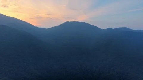 Sunset colors blend sky and distant mountains Video stock 339864602