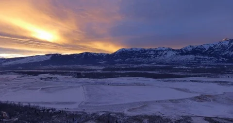Sunset Colors Magic Hour Mountain light Snow Covered Peaks Grand Tetons Wyoming Video stock 87199314