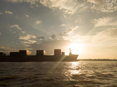 Sunset with the container ship Stock Photos