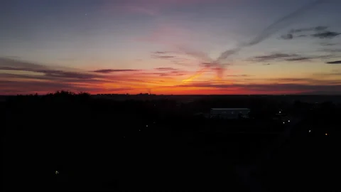 Sunset contrasting landscape. Red sky and black earth below. Stock Footage 172347387
