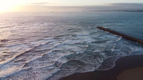 Sunset in Costa da Caparica beach in Portugal with small Fishing Boat Passing By Video stock 145440232