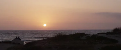 Sunset with couple beach on bench 4k Video stock 49698305