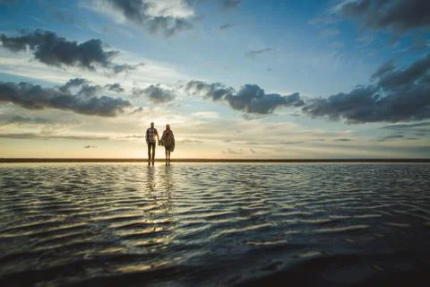 Sunset couple at the sea Stock Photos