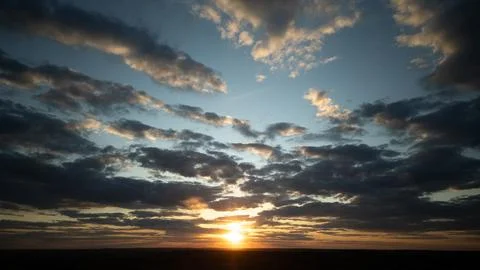 Sunset creating dramatic sky with golden light and clouds Stock Photos