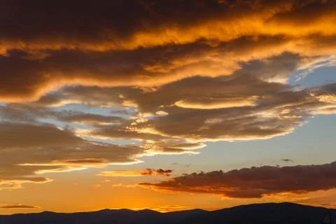 Sunset with dark heavy clouds, beautiful landscape Stock Photos