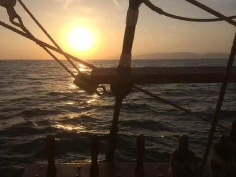 Sunset from deck of tall ship Stock Photos