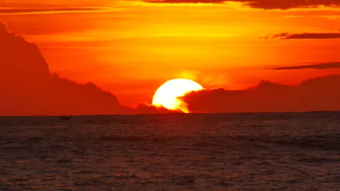 Sunset in deep ocean, silhouette mountain cape long distance with beautiful c Stock Footage 130892848