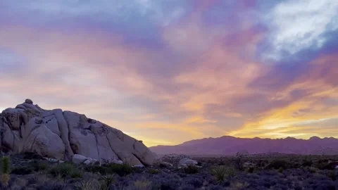Sunset in the Desert against a backdrop of boulders Stock Footage 317667907