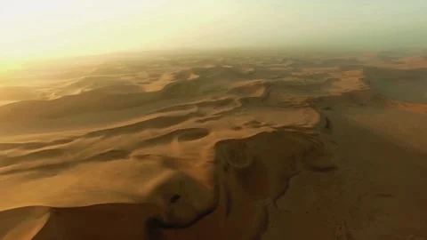 Sunset desert drone, endless sand dunes, golden hour landscape Stock Footage 310033233