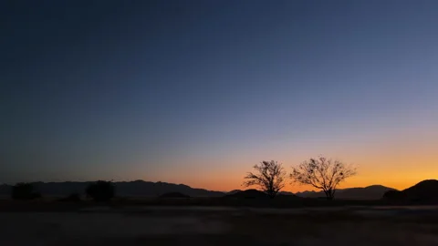 Sunset in desert in Namibia, Africa. Timelapse. Orange blue sky time lapse dawn. Stock Footage 168905511