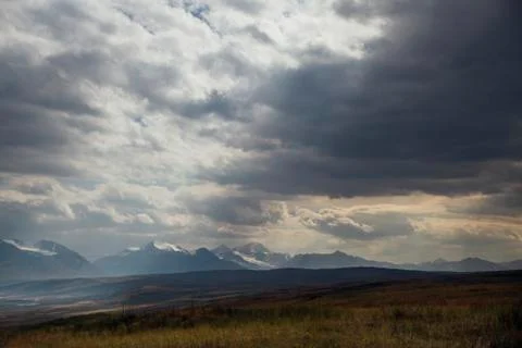 Sunset in the desert, the sun's rays Shine through the clouds. Ukok Plateau O Stock Photos